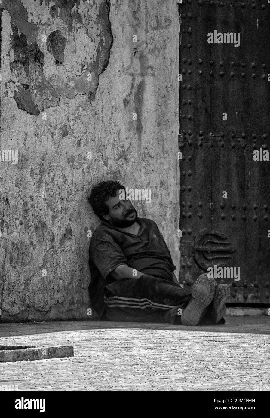 A man resting on the outskirts of Tangier`s medina. Morocco. Stock Photo
